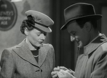 Movie still from “Brief Encounter” (1945), directed by David Lean – A man and a woman looking at each other; Medium shot, Low angle