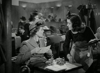 Movie still from “Brief Encounter” (1945), directed by David Lean – Two women sitting at a table in a restaurant; Medium shot, Over the shoulder angle