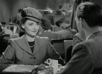 Movie still from “Brief Encounter” (1945), directed by David Lean – An old photo of two people sitting at a table; Medium shot, Over the shoulder angle