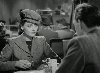 Movie still from “Brief Encounter” (1945), directed by David Lean – An old photo of two people sitting at a table; Medium shot, Over the shoulder angle