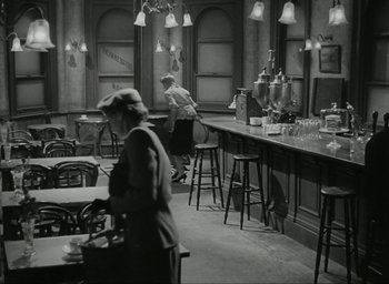Movie still from “Brief Encounter” (1945), directed by David Lean – Two people are sitting at a bar in a restaurant; Wide shot, High angle