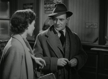 Movie still from “Brief Encounter” (1945), directed by David Lean – An old photo of a man and a woman talking; Medium shot, Over the shoulder angle