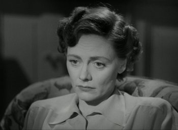 Movie still from “Brief Encounter” (1945), directed by David Lean – An old photo of an older woman sitting in a chair; Close Up shot, High angle