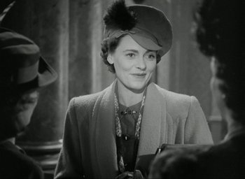 Movie still from “Brief Encounter” (1945), directed by David Lean – An old photo of a woman wearing a hat; Medium shot, Over the shoulder angle