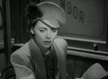 Movie still from “Brief Encounter” (1945), directed by David Lean – A woman wearing a hat sitting in front of a mirror; Close Up shot, Low angle