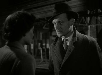 Movie still from “Brief Encounter” (1945), directed by David Lean – A man and a woman are standing in front of each other; Close Up shot, Low angle