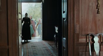 Movie still from “Bright Star” (2009), directed by Jane Campion – A group of people standing in a doorway; Wide shot, Over the shoulder angle