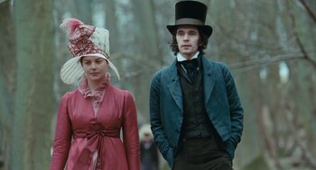 Movie still from “Bright Star” (2009), directed by Jane Campion – A man and a woman wearing hats standing next to each other; Medium shot, Low angle