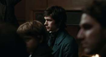 Movie still from “Bright Star” (2009), directed by Jane Campion – A man in a suit and tie standing next to another man in a suit and tie; Close Up shot, Over the shoulder angle