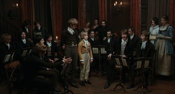 Movie still from “Bright Star” (2009), directed by Jane Campion – A group of people sitting in a room; Wide shot, High angle
