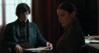 Movie still from “Bright Star” (2009), directed by Jane Campion – A man and a woman sitting in front of each other holding a book; Medium shot, Over the shoulder angle