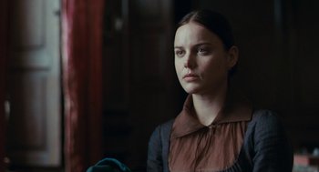 Movie still from “Bright Star” (2009), directed by Jane Campion – A woman in a brown and black dress looking to her left; Close Up shot, Over the shoulder angle