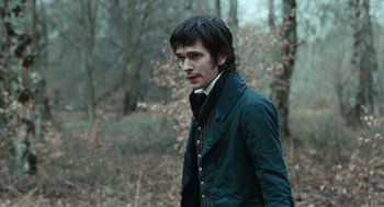 Movie still from “Bright Star” (2009), directed by Jane Campion – A man in a jacket walking through the woods; Close Up shot, Over the shoulder angle