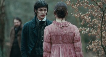 Movie still from “Bright Star” (2009), directed by Jane Campion – A man and a woman standing next to each other in front of a tree; Medium shot, Over the shoulder angle