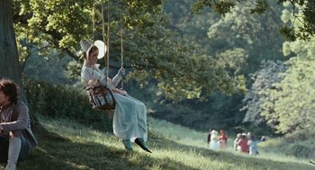 Movie still from “Bright Star” (2009), directed by Jane Campion – A woman is swinging on a swing in a park; Wide shot, High angle