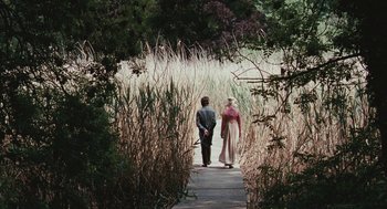 Movie still from “Bright Star” (2009), directed by Jane Campion – A man and a woman are walking through tall grass; Wide shot, Over the shoulder angle