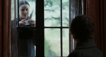 Movie still from “Bright Star” (2009), directed by Jane Campion – A woman looking out of a window at a child; Medium shot, Over the shoulder angle