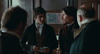 Movie still from “Bright Star” (2009), directed by Jane Campion – Two men are standing in a room talking; Medium shot, Over the shoulder angle