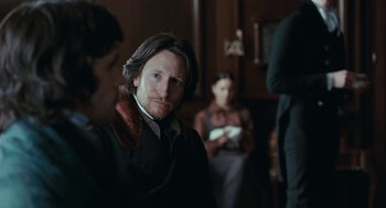 Movie still from “Bright Star” (2009), directed by Jane Campion – A group of people standing in a room; Close Up shot, Over the shoulder angle