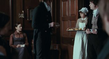 Movie still from “Bright Star” (2009), directed by Jane Campion – A man and a woman standing next to each other holding a tray of food; Medium shot, Over the shoulder angle