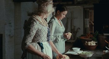 Movie still from “Bright Star” (2009), directed by Jane Campion – Two women standing next to each other preparing food; Medium shot, High angle