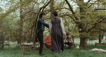 Movie still from “Bright Star” (2009), directed by Jane Campion – A man and a woman standing in the grass; Wide shot, Over the shoulder angle