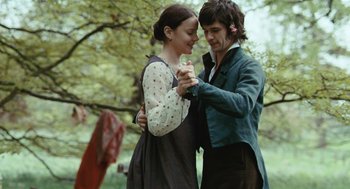 Movie still from “Bright Star” (2009), directed by Jane Campion – A man and a woman holding each other in a park; Medium shot, Over the shoulder angle