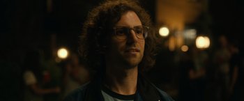 A person wearing glasses and a jacket