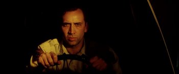 Movie still from “Bringing Out the Dead” (1999), directed by Martin Scorsese – A man holding a steering wheel in the dark; Close Up shot, Low angle