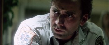 Movie still from “Bringing Out the Dead” (1999), directed by Martin Scorsese – A person looking at the camera; Close Up shot, Low angle