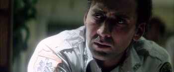 Movie still from “Bringing Out the Dead” (1999), directed by Martin Scorsese – A man's face as he stares into the camera; Close Up shot, Over the shoulder angle