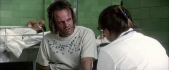 Movie still from “Bringing Out the Dead” (1999), directed by Martin Scorsese – A man and a woman are talking in a room; Close Up shot, Over the shoulder angle