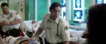 Movie still from “Bringing Out the Dead” (1999), directed by Martin Scorsese – A man with a stethoscope around his neck is standing in a hospital room; Close Up shot, Over the shoulder angle