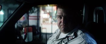 Movie still from “Bringing Out the Dead” (1999), directed by Martin Scorsese – A person in a police car; Close Up shot, Low angle