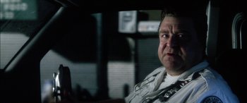 Movie still from “Bringing Out the Dead” (1999), directed by Martin Scorsese – A police officer sitting in a car at night; Close Up shot, Low angle