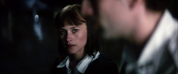 Movie still from “Bringing Out the Dead” (1999), directed by Martin Scorsese – A person wearing a suit and tie; Close Up shot, Over the shoulder angle