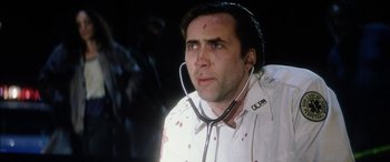 Movie still from “Bringing Out the Dead” (1999), directed by Martin Scorsese – A man with blood all over his face is holding a stethoscope; Close Up shot, Low angle