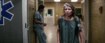 Movie still from “Bringing Out the Dead” (1999), directed by Martin Scorsese – An older woman standing in front of an older man; Medium shot, Low angle