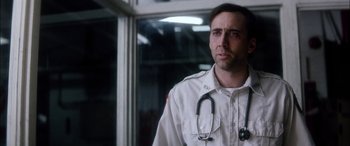 Movie still from “Bringing Out the Dead” (1999), directed by Martin Scorsese – A man with a stethoscope around his neck; Close Up shot, Low angle