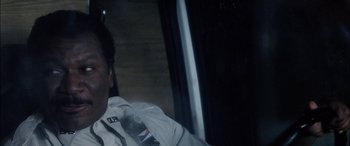 Movie still from “Bringing Out the Dead” (1999), directed by Martin Scorsese – A man sitting in the back seat of a car; Close Up shot, Low angle