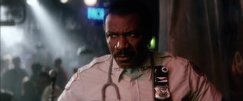 Movie still from “Bringing Out the Dead” (1999), directed by Martin Scorsese – A police officer with a stethoscope around his neck; Close Up shot, Low angle