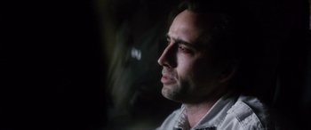 Movie still from “Bringing Out the Dead” (1999), directed by Martin Scorsese – A person wearing a white shirt; Close Up shot, Over the shoulder angle