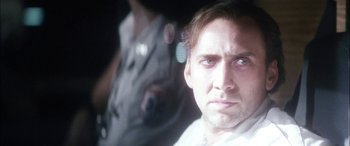 Movie still from “Bringing Out the Dead” (1999), directed by Martin Scorsese – A person wearing a white shirt; Close Up shot, Over the shoulder angle