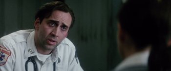 Movie still from “Bringing Out the Dead” (1999), directed by Martin Scorsese – A person talking to another person; Close Up shot, Over the shoulder angle