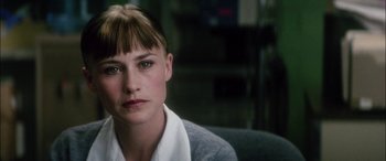 Movie still from “Bringing Out the Dead” (1999), directed by Martin Scorsese – A person sitting down wearing a sweater; Close Up shot, Over the shoulder angle