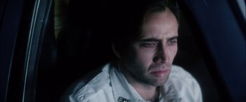 Movie still from “Bringing Out the Dead” (1999), directed by Martin Scorsese – A person wearing a white shirt; Close Up shot, Over the shoulder angle