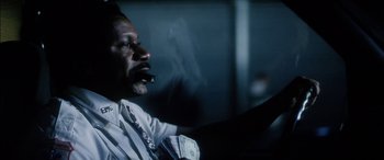 Movie still from “Bringing Out the Dead” (1999), directed by Martin Scorsese – A man sitting in a car holding a steering wheel; Close Up shot, Low angle