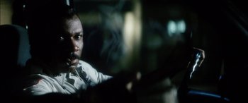 Movie still from “Bringing Out the Dead” (1999), directed by Martin Scorsese – A black man is looking at the camera; Close Up shot, Low angle