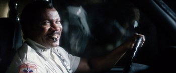 Movie still from “Bringing Out the Dead” (1999), directed by Martin Scorsese – An older man driving a car with his mouth open; Close Up shot, Over the shoulder angle