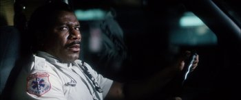 Movie still from “Bringing Out the Dead” (1999), directed by Martin Scorsese – A police officer in a uniform in the dark; Close Up shot, Low angle